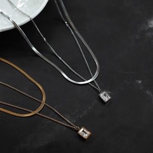 GoldbStainless steel double layer clavicle chain and diamond pendent necklace.